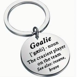 silver disk keyring with the words "Goalie - the craziest player on the team" inscribed on it