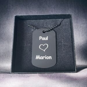 Dog tag with Paul loves Marion engraved onto it