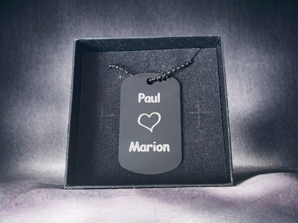 Dog tag with Paul loves Marion engraved onto it