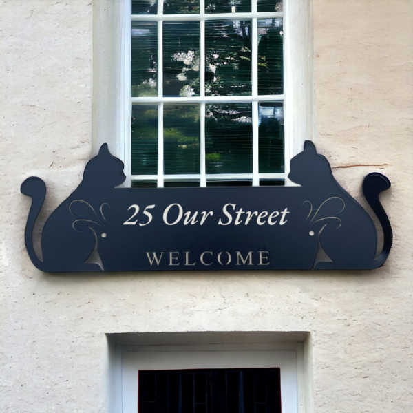 Black name plaque on the front of house