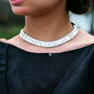 a lady wearing a black dress with a crystal choker necklace