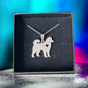 Necklace with a samoyed dog pendant on a blue coloured background