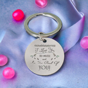 Circular keyring with wording "Granddaugher I love you and am so proud of you"