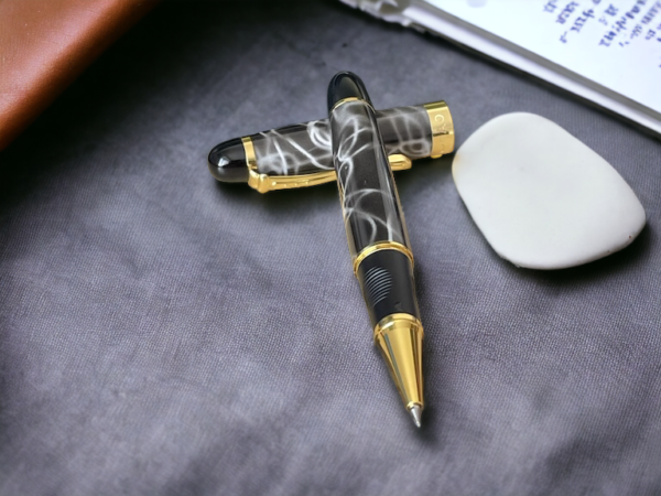 Grey marble rollerball pen on a grey fabric background