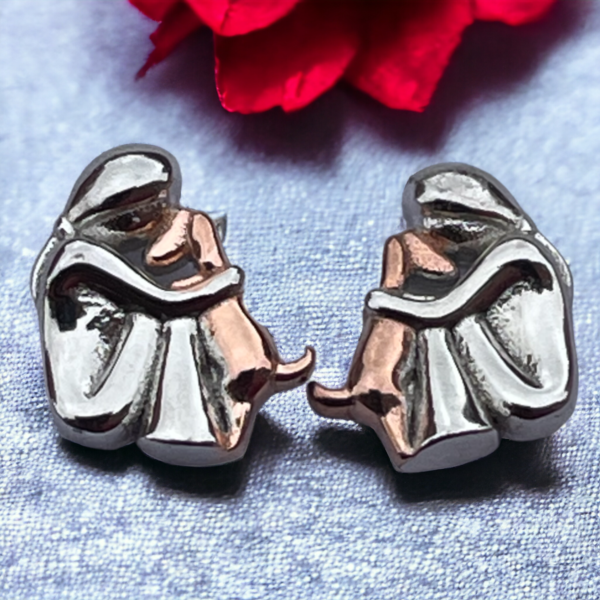 silver stud earrings showing a girl hugging a dog