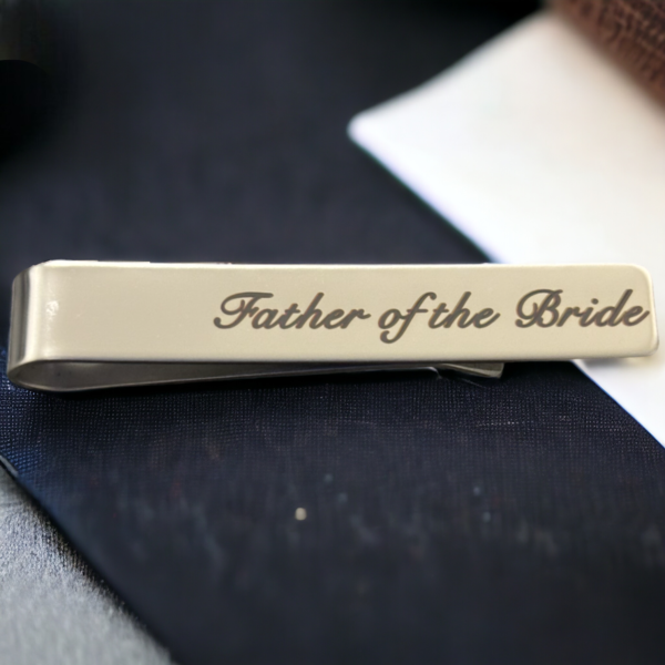 tie clip on a black background reading 'Father of the Bride'