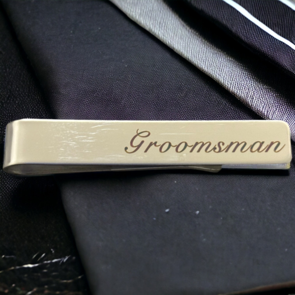 tie clip on a black background reading 'Groomsman'