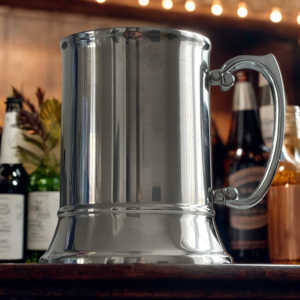 steel tankard on a bar with bottles in the backroom